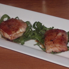 Recept: Geitenkaas in spek met honingdressing op rucola